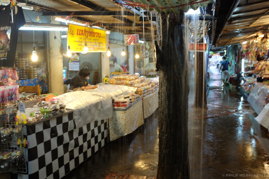 A “floating market” in Ayutthaya with water coming from above.